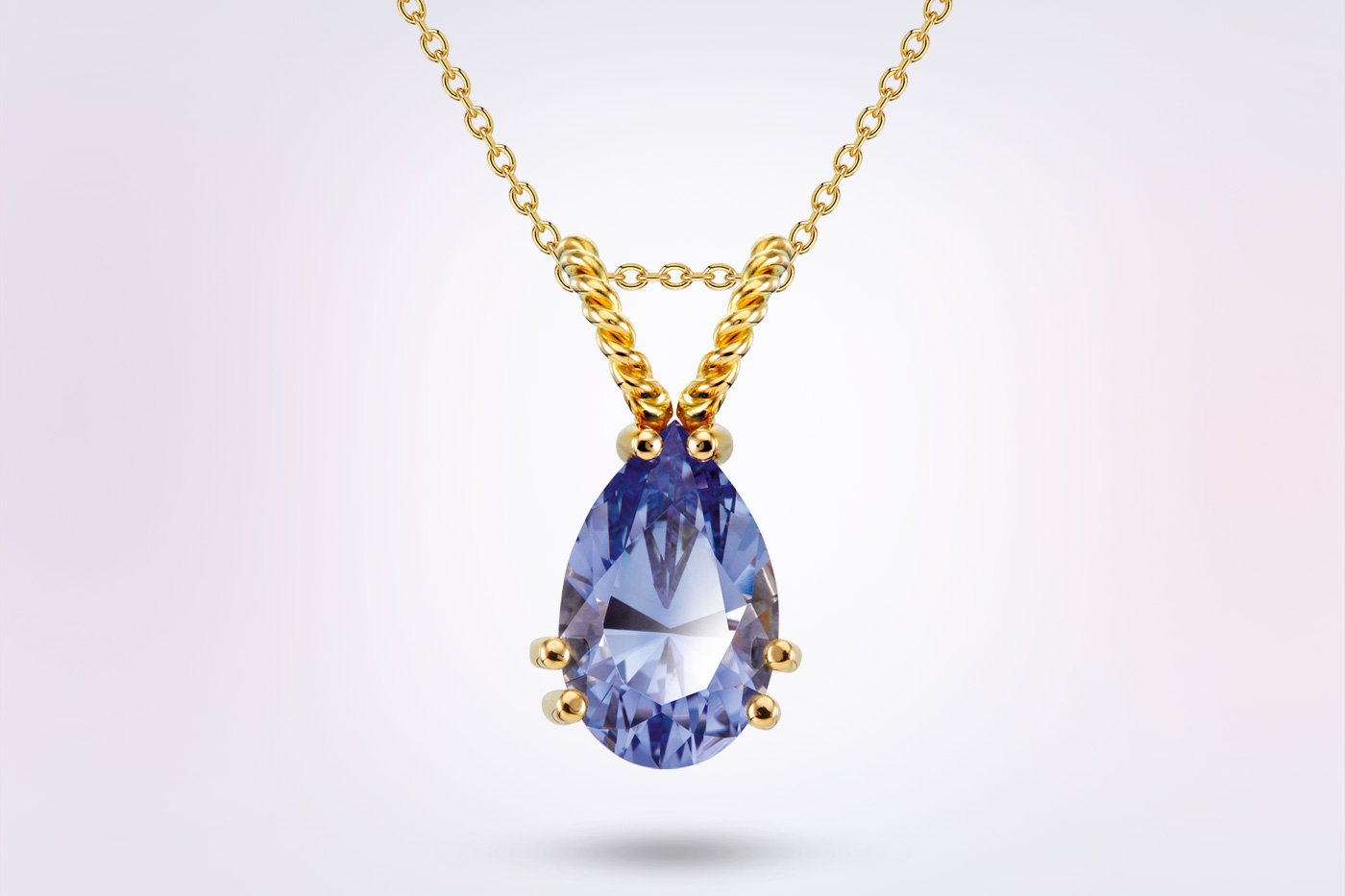 Mevisto Saphir Kettenanhänger Gelbgold | Märtin Bestattungen Eleganter Goldanhänger mit einem tropfenförmigen blauen Mevisto Saphir als persönlicher Erinnerungsschmuck aus Asche oder Haaren.